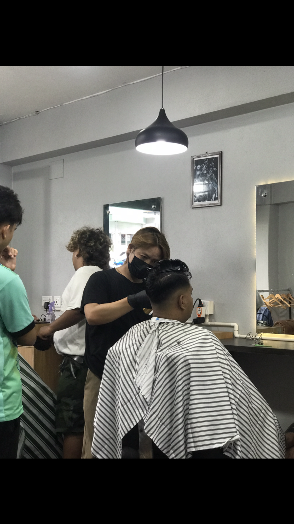 Ayu's Barber team working with clients inside the shop