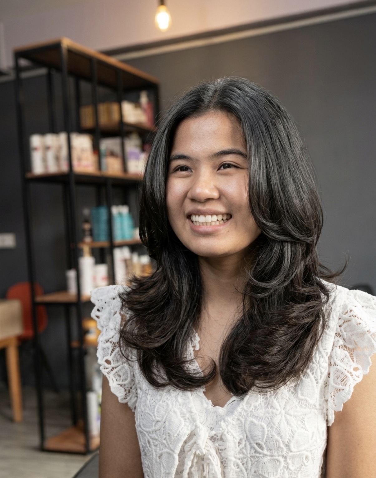 Front portrait of a layered women's haircut with soft face-framing shape