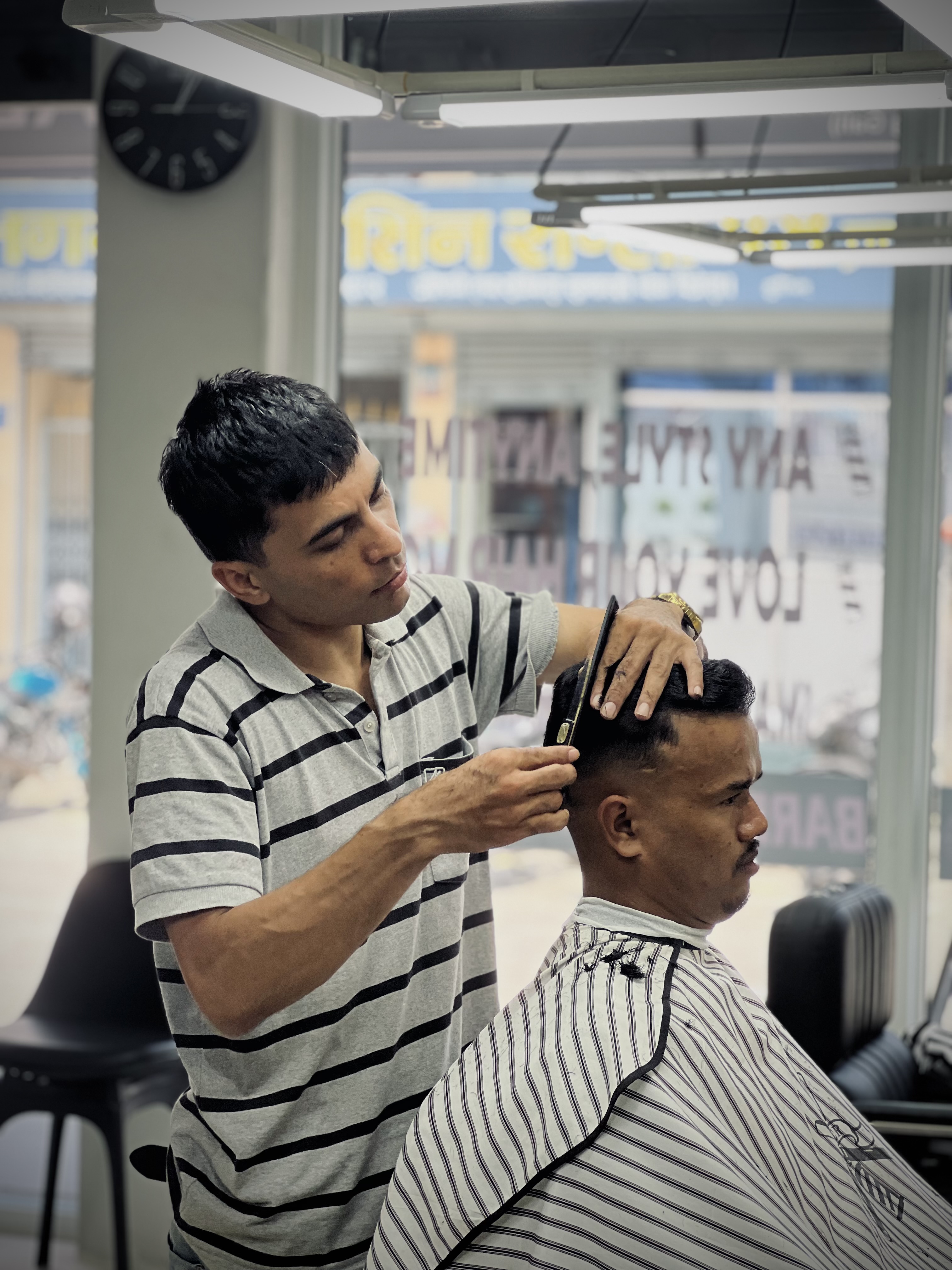 Portrait of Pradip Kunwar holding barber clippers