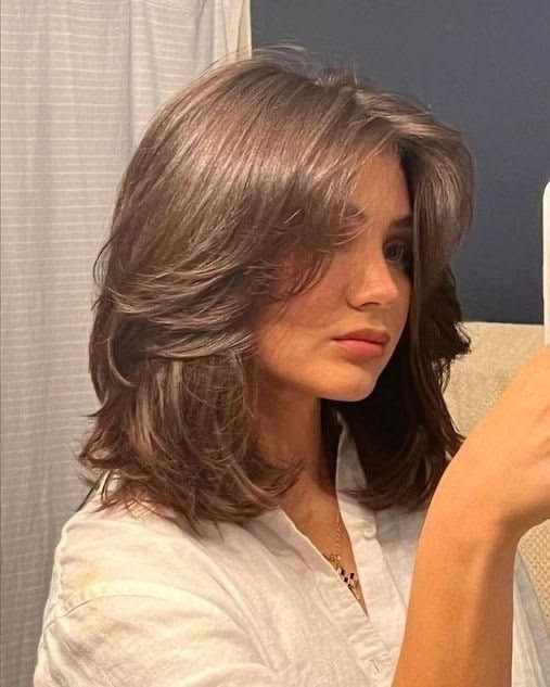 Front portrait of face framing layered women's hairstyle